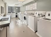 Thumbnail 12 of 17 - A laundromat with washers and dryers lined up.
