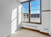 Thumbnail 5 of 24 - an empty room with large windows and a carpeted floor