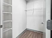Thumbnail 9 of 22 - an empty room with white closets and wood flooring