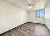 Thumbnail 10 of 17 - Empty room with a window and a ceiling fan.