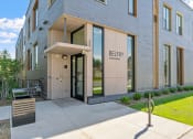 Thumbnail 44 of 45 - the belby apartments exterior entrance with sidewalk and grass
