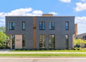 Thumbnail 45 of 45 - a large gray building with a street in front of it
