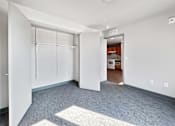 Thumbnail 8 of 22 - a renovated living room with white walls and white closet doors