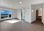 Thumbnail 5 of 22 - a renovated living room with a large window and wood flooring