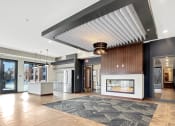Thumbnail 8 of 36 - a lobby with a fireplace and a large rug