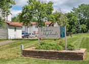 Thumbnail 7 of 23 - A sign for Vashon's Highlands is in the foreground of a grassy area.