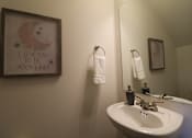 Thumbnail 37 of 37 - A bathroom with a framed picture that says "I love you to the moon and back".