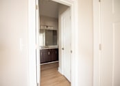 Thumbnail 7 of 47 - A white door is open to a small kitchen.