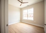 Thumbnail 2 of 47 - A room with a ceiling fan and a window.