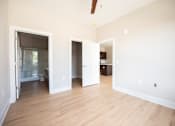 Thumbnail 14 of 47 - A room with a white wall and a wooden floor.