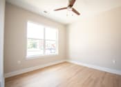 Thumbnail 17 of 47 - Empty room with a window and a ceiling fan.