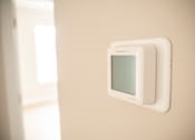 Thumbnail 23 of 47 - A wall-mounted device with a screen is mounted on a wall.