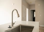 Thumbnail 26 of 47 - A modern kitchen sink with a chrome faucet.