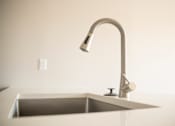 Thumbnail 28 of 47 - A modern kitchen sink with a chrome faucet.