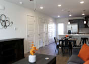 Thumbnail 32 of 37 - A modern living room with a fireplace and a dining area.