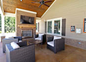 Thumbnail 11 of 37 - A patio with a fireplace and chairs.