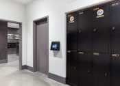 Thumbnail 33 of 35 - a row of lockers in a hallway with a television on the wall
