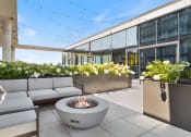 Thumbnail 23 of 35 - an outdoor patio with couches and a fire pit