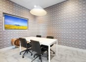 Thumbnail 20 of 35 - a meeting room with a white table and black chairs
