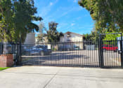 Thumbnail 1 of 8 - the gate to the parking lot of a house with cars behind it
