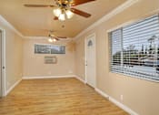 Thumbnail 54 of 56 - an empty living room with a ceiling fan and a window