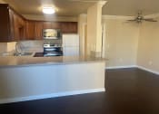 Thumbnail 5 of 8 - an empty kitchen with an island in the middle of it