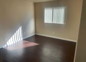 Thumbnail 6 of 8 - an empty bed room with wood floors and a window