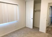 Thumbnail 20 of 29 - a room with a closet and a window and a door