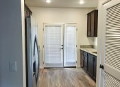 Thumbnail 8 of 29 - a kitchen with a refrigerator and a door to a closet