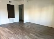 Thumbnail 14 of 29 - an empty living room with white walls and wood floors