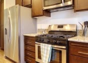 Thumbnail 9 of 29 - a kitchen with a stove and a refrigerator