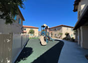 Thumbnail 24 of 29 - a playground in the middle of a sidewalk between two houses