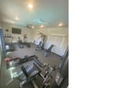 Thumbnail 27 of 29 - a gym with a lot of chairs and exercise equipment