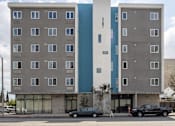 Thumbnail 6 of 19 - A modern building with a blue and white section on the side.