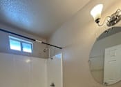 Thumbnail 6 of 13 - A white toilet in a bathroom with a sink and mirror.
