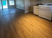 Thumbnail 2 of 13 - A kitchen with a stove top oven and a window.