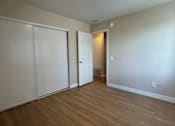 Thumbnail 4 of 13 - A room with a white door and a white wall.