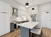 Thumbnail 11 of 21 - A modern kitchen with a white countertop and grey cabinets.