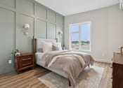 Thumbnail 4 of 21 - A bedroom with a large bed and a window overlooking the beach.