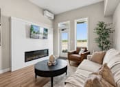 Thumbnail 16 of 21 - A living room with a fireplace and a flat screen TV mounted on the wall.
