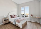 Thumbnail 21 of 21 - A bedroom with a large bed and a window overlooking a parking lot.