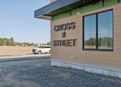 Thumbnail 19 of 21 - A building with a sign that says "CROSS STREET" on it.