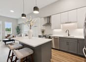 Thumbnail 10 of 21 - A modern kitchen with a large island and bar stools.