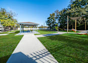 Thumbnail 61 of 61 - A park with a pavement leading to a pavilion. at Red Bay Apartment Complex, Jacksonville, FL, 32211