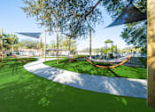 Thumbnail 29 of 61 - A playground with a slide and a swing set. at Red Bay Apartment Complex, Jacksonville, FL, 32211