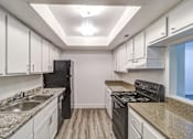 Thumbnail 52 of 61 - a kitchen with white cabinets and black appliances at Red Bay Apartment Complex, Jacksonville, Florida