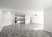 Thumbnail 11 of 61 - A spacious kitchen and living room with a grey wood floor. at Red Bay Apartment Complex, Jacksonville, FL, 32211