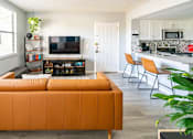 Thumbnail 18 of 29 - a living room with a couch and a kitchen with a table and chairs at Bella Lago Vista, West Palm Beach, Florida