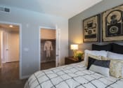 Thumbnail 20 of 28 - a bedroom with a bed and a nightstand with a lamp