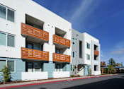 Thumbnail 2 of 12 - a row of apartment buildings with blue and white facade and wooden balconies